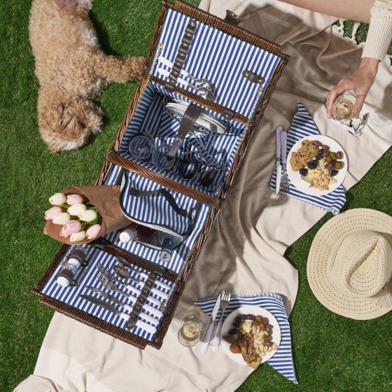 Enjoy refined al fresco dining with our woven Wicker Picnic Basket. Two insulated compartments keep your picnic fare a perfect temperature while the sturdy handle makes it easy to carry. Set includes basket, white Truetap corkscrew, salt and pepper shakers set, and 4 each of silverware, plates, wine glasses, and cotton napkins. Accommodates 1 standard wine bottle and food. Basket measures 18 x 13 x 16.5 Spot Clean Only.Makes a great gift.